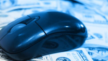computer mouse on top of $100 bills